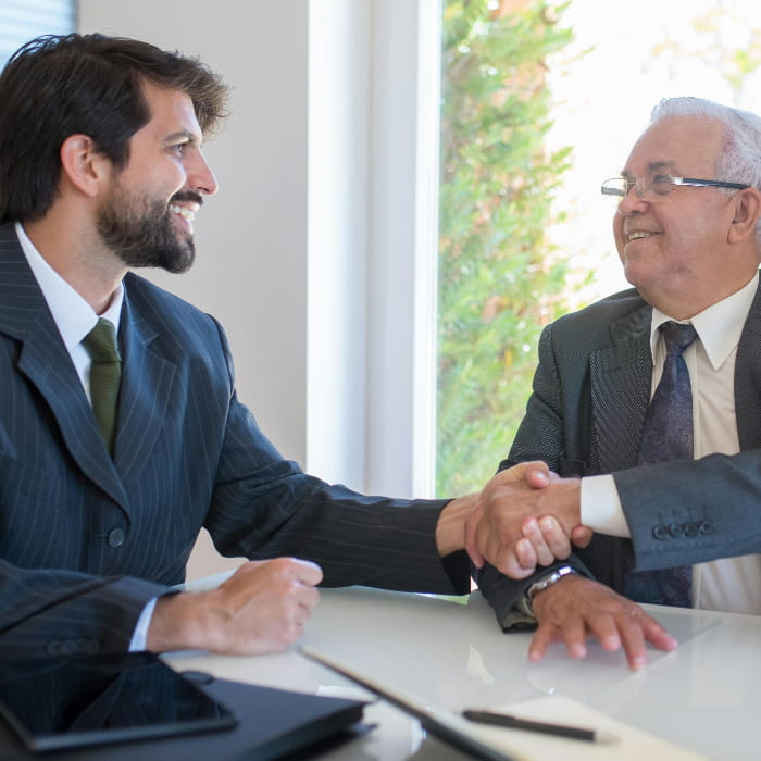 Client shaking hands with attorney Dave Falvey